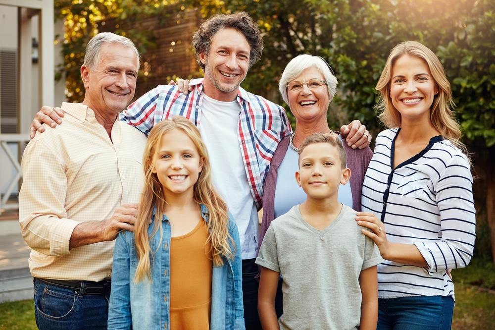Family smiling to the compassionate dental team after consultation on teeth grinding